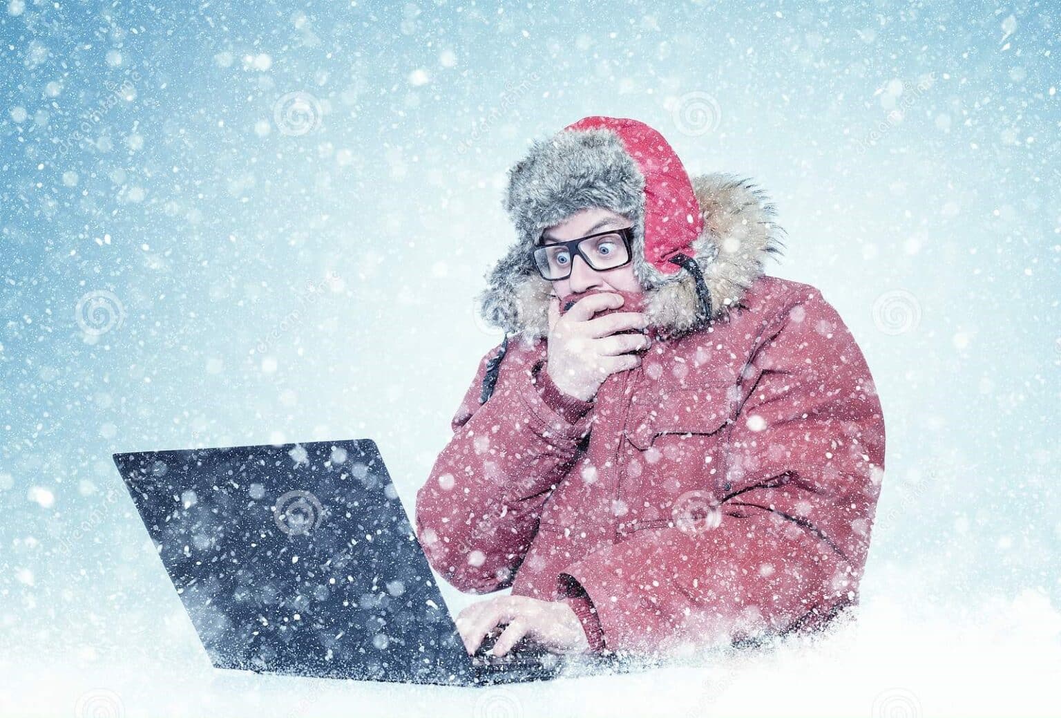 frozen man red winter clothes glasses working laptop snow cold frost blizzard computer 132909184 1536x1039 1